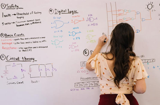 Woman drawing circuits on a whiteboard