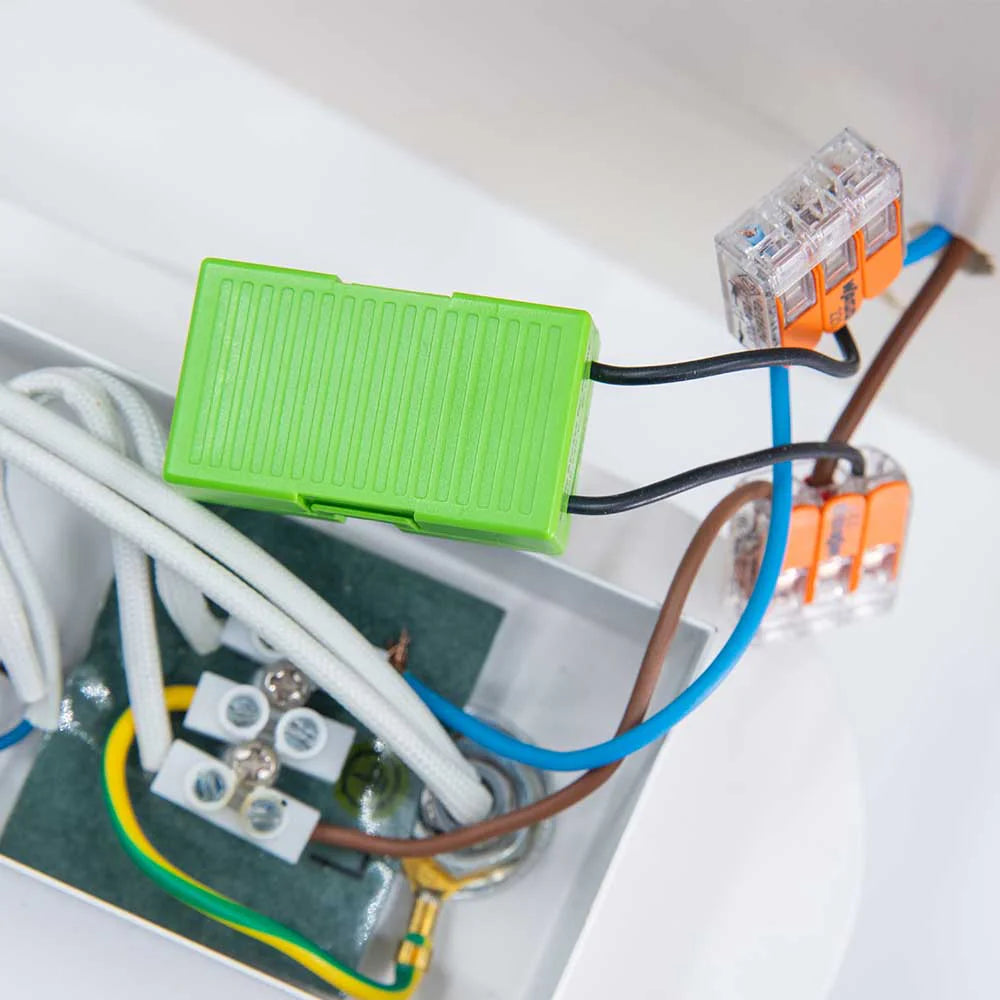Electrical wiring with green connector and various cables on a white background | Lykalyte