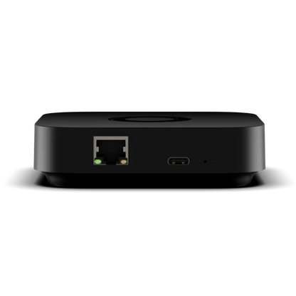 Homey Pro Mini back view with rounded corners, featuring a RJ45 Ethernet port with a green indicator light and a USB-C port on the front, shown against a plain white background. | Lykalyte